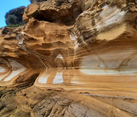 Multicoloured ochre and brown cliffs with internal patterns in white
