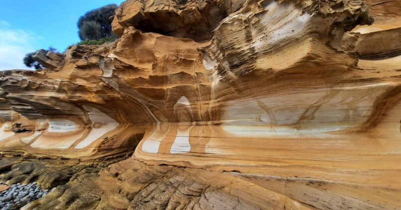 Multicoloured ochre and brown cliffs with internal patterns in white