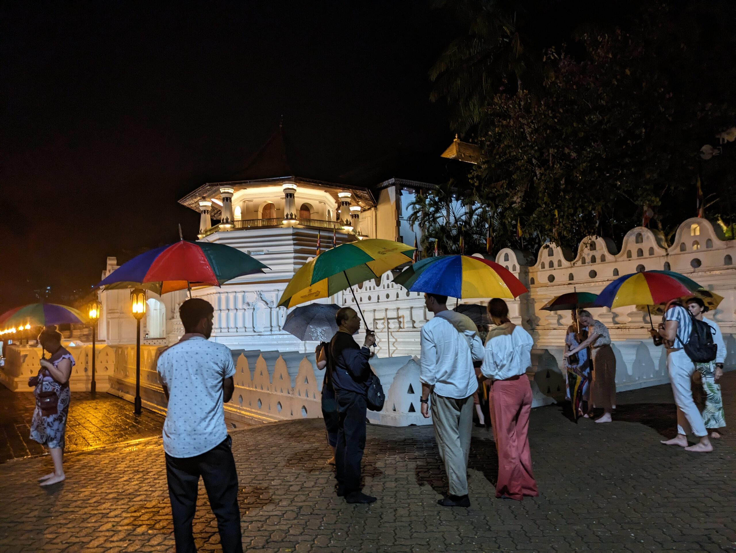 Visitors at Kandy Temple: Rain, Hail or Shine © Marjie Courtis