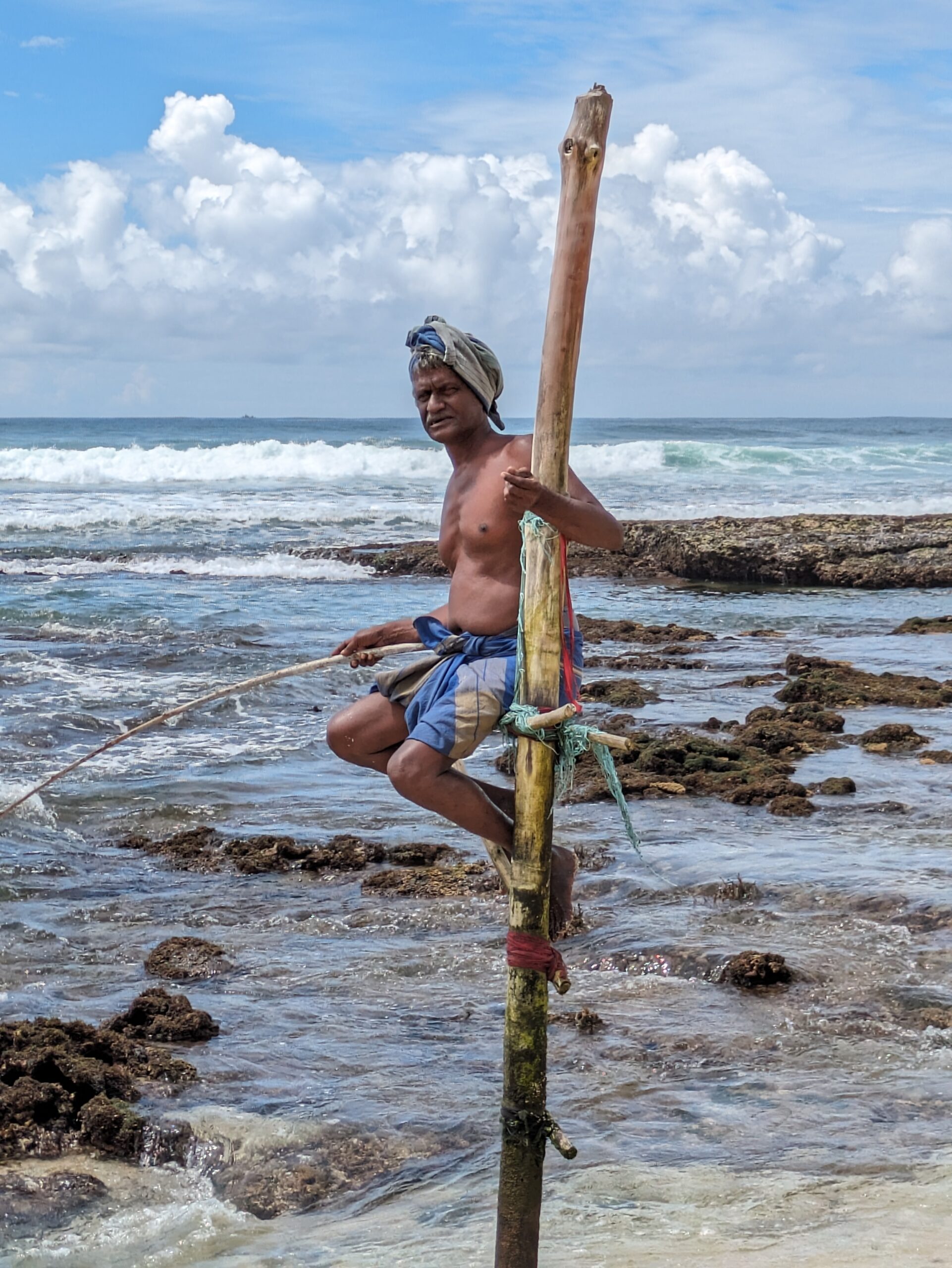 A stilt fisherman on Koggala Beach © Marjie Courtis